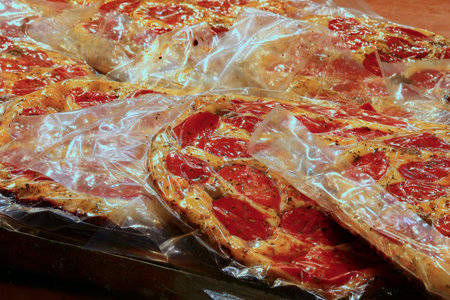 pizza with cheese and red tomatoes vacuum packed with an airtight bag on sale at the Italian market stallの写真素材