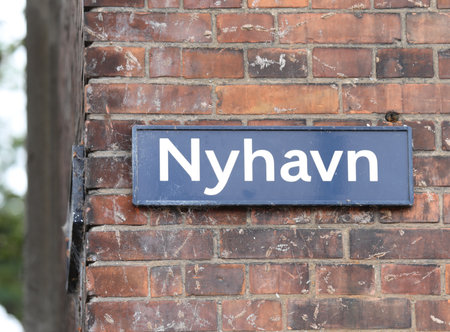 Text in Danish NYHAVN which means new harbor is the district of Copenhagen in Denmark with canal and very famous colored housesの写真素材