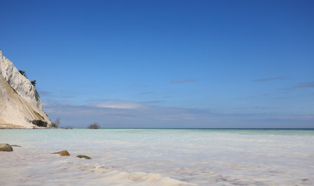 stunning view of the white sea caused by calcium carbonate sand with a cliff eroding due to natural elements on the southern Danish island called Mons Klintの写真素材