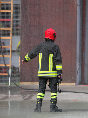 fire chief wearing red helmet and uniform during training and rescue operations
