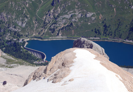 Marmolada glacier and artificial lake called Fedaia lago which collects the melting water of the glacierの写真素材