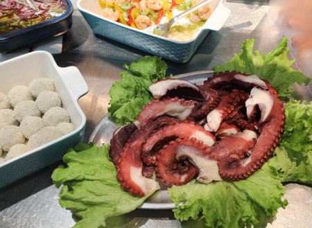 fresh octopus tentacles for sale at the restaurant specializing in seafood dishesの写真素材