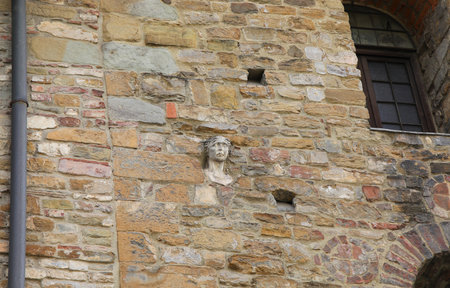 ancient face discovered embedded in florence medieval tower in italyの写真素材