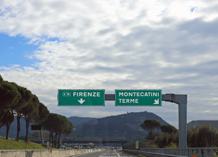 Road junction with signs to go to Florence or to Montecatini Terme a well known spa town in central Italyの写真素材