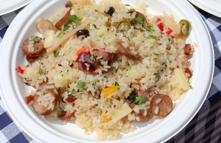 plate full of rice salad a typical European summer dish with sausage vegetables and cheeseの写真素材