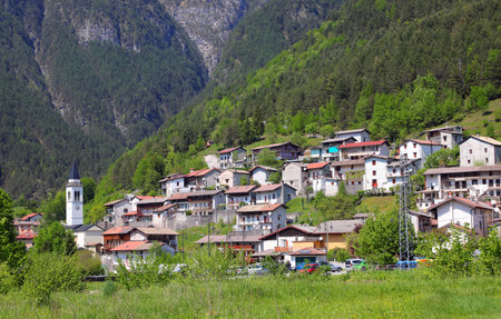 Small Village called Slizza di Resia in Northern Italy with houses and bell tower of churchの写真素材
