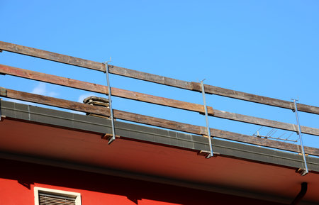 Securely installed safety barrier for workers safety to prevent falls during maintenance work on the...