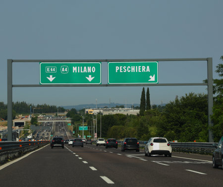 motorway with the portal and directions to the cities of MILAN or to PESCHIERA the city near Lake Gardaの写真素材