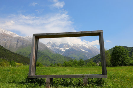 wooden frame and the alps in the background in Northern Italy in summerの写真素材