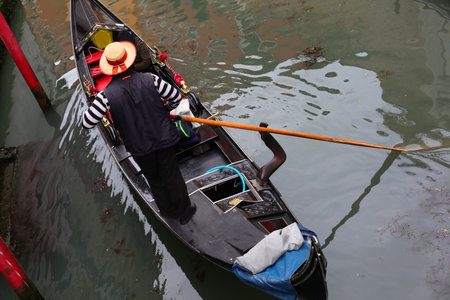 Gondolier in the Gondola boat in Venetian waterway in Venice Island in Northern Italyの写真素材