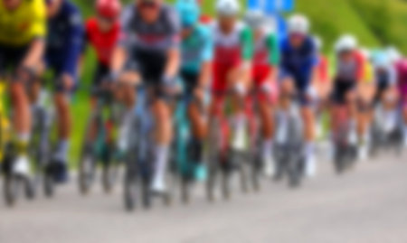 Intentionally blurred cyclist manys in a group pedaling during a competitive road raceの写真素材