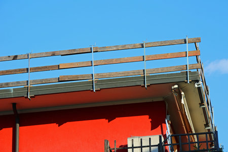 detail of the corner of the roof of the apartment building with the barrier firmly installed for the...
