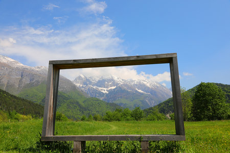 wooden frame and the European alps in the background in Northern Italyの写真素材