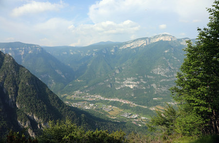 very suggestive and panoramic view from above of the Alps in northern Italy that the valleys and the small townの写真素材