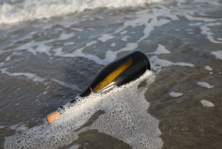 glass bottle stranded by the sea with a secret message inside or the map of a concealed pirate treasureの写真素材