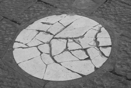 circular mark on the square indicating the spot where the very large and extremely heavy golden sphere fell from Florences Duomo Dome in Italyの写真素材