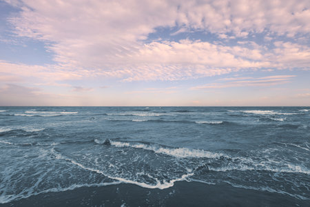 sea below with waves and sky above with white clouds ideal background with concept of nature relaxation and beach vacationの写真素材