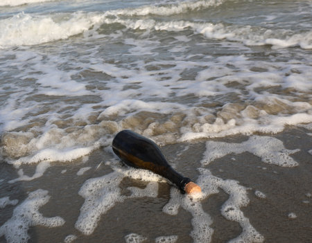 Glass bottle with cork stopper washed ashore perhaps containing a secret message or a pirate treasure mapの写真素材