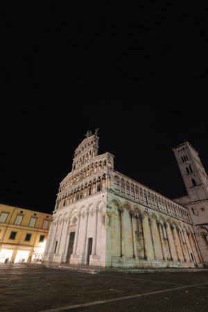 Church of San Michele in Lucca in the Tuscany region of Italy at night with street lights onの写真素材