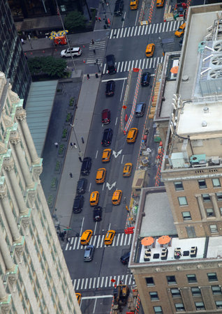 view from above of the traffic-filled city street with many yellow taxis and cars that look like...