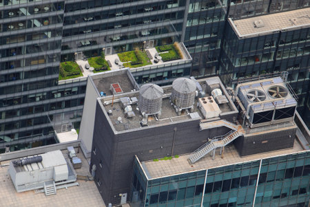 high angle view of the modern skyscrapers and the ventilation systems with large fans and the tanks...