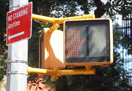 Illuminated red hand pedestrian signal in New York City intersection