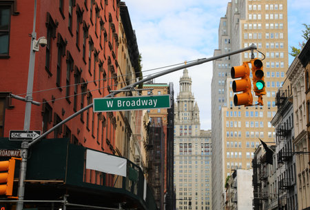 Traffic signal and W Broadway street sign at Manhattan New York intersection with tall skyscrapersの写真素材