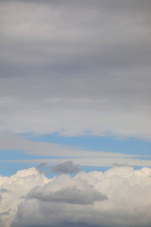 vertical sky with clouds above and below the deep blue center