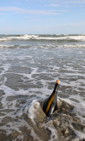 glass bottle found on the beach sealed with a cork containing a secret message or a treasure mapの写真素材