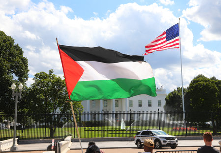 Washington, DC, USA - August 26, 2025: palestinian and american flags waving with the white house...