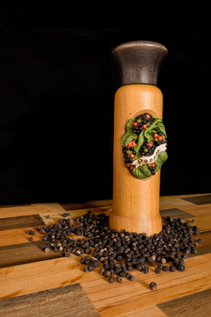brown pepper grinder in a wood tableの写真素材