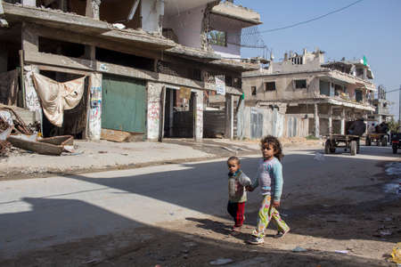 Gaza Strip, children play and live on the street amidst the rubble after the bombingsのeditorial素材