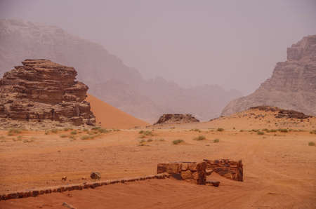Landscape with ancient stone wall on a foggy day in Wadi Rum, Jordanの写真素材