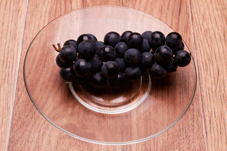 fragrant, mouth-watering berries is located on the transparent, beautiful plateの写真素材