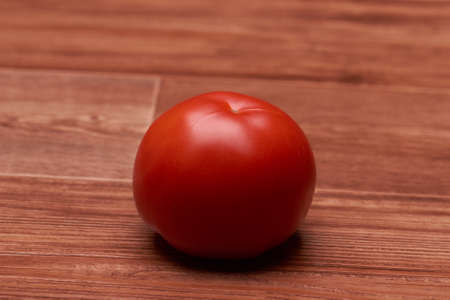 tasty, beautiful, red vegetable lies on a large tableの写真素材