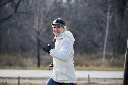 Woman in white running clothes go jogging