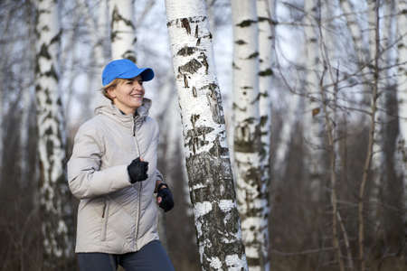 Woman in running clothes go joggingの写真素材