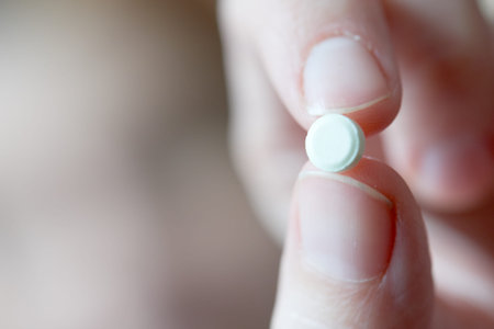 one white pills in old men's handsの写真素材