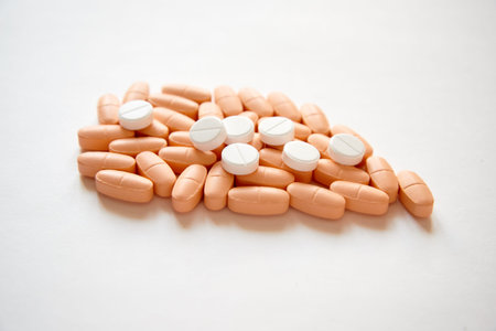 Stack of different pills on white background