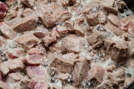 Fried meat in a frying pan closeup. Top viewの写真素材