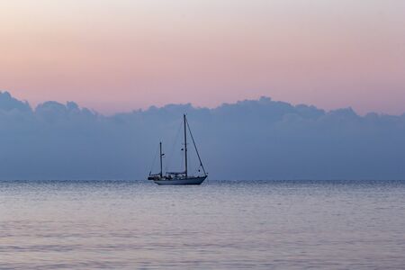Beautiful view to the sailboat on bay at sunrise in Turkeyの写真素材