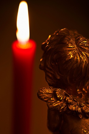 The angel and the burning candle.の写真素材