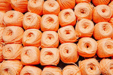 orange woolen threads in a ball for knitting close-upの写真素材