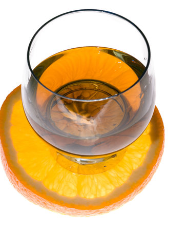 Cognac glass and slice of orange on whiteの写真素材