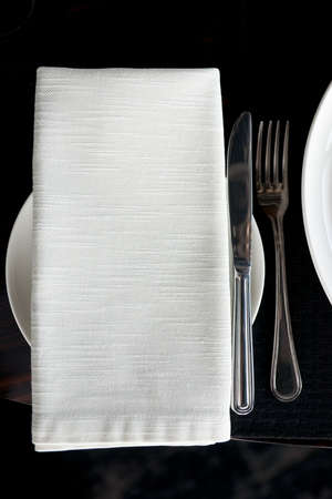 Napkin and silverware on restaurant tableの写真素材