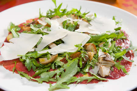 Salad of prosciutto, mushrooms, ruccola and cheese - italian cuisineの写真素材