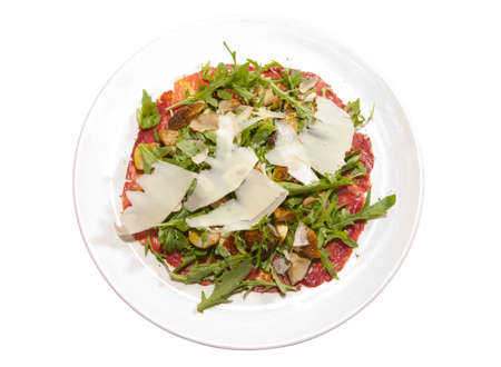 Carpaccio of prosciutto, mushrooms, ruccola and cheese isolated on whiteの写真素材