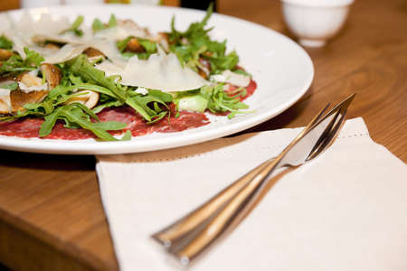 Italian carpaccio on tesraurant table, with fork and knifeの写真素材