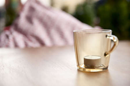 Candle in glass on restaurant table, close-upの写真素材