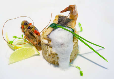 Rice with shrimp and grilled fish slice on white plate, close-upの写真素材